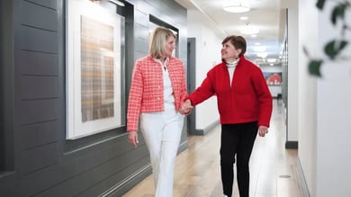 Nurse walking resident down a hall