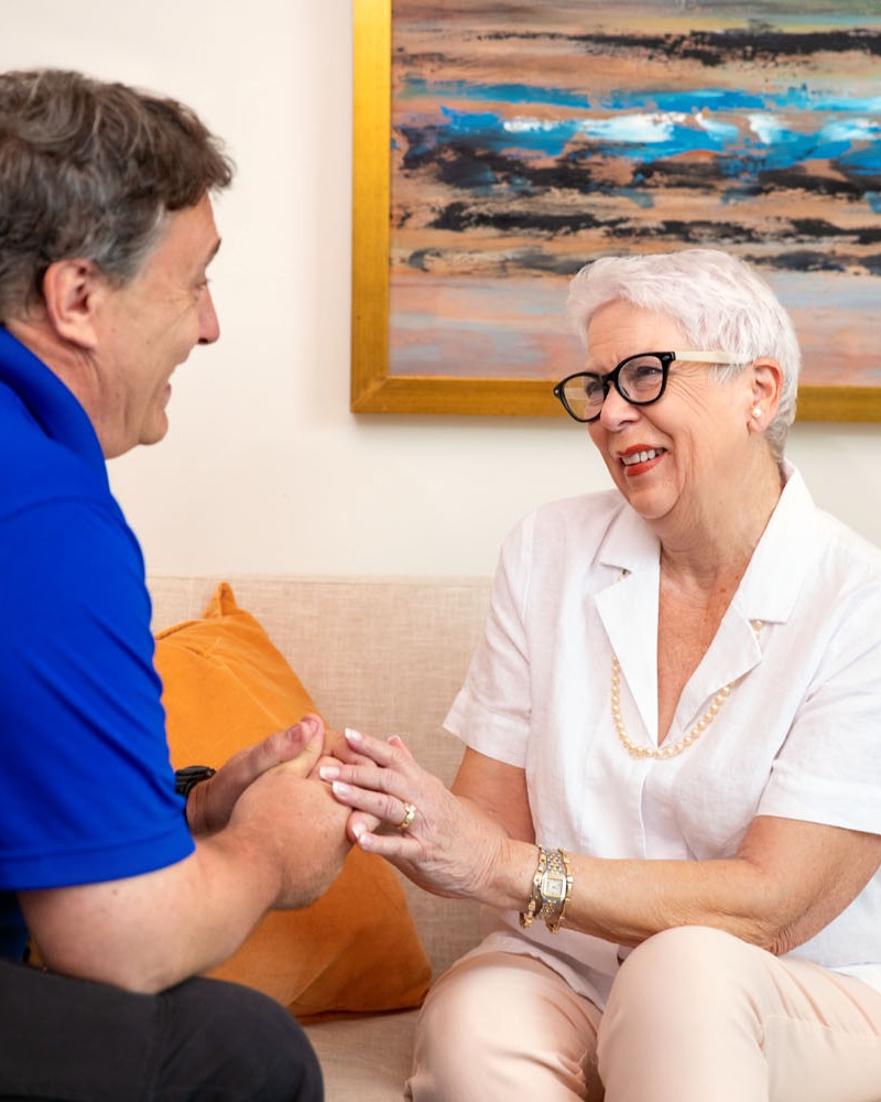 Senior citizen couple sitting on couch in Marlton senior living home