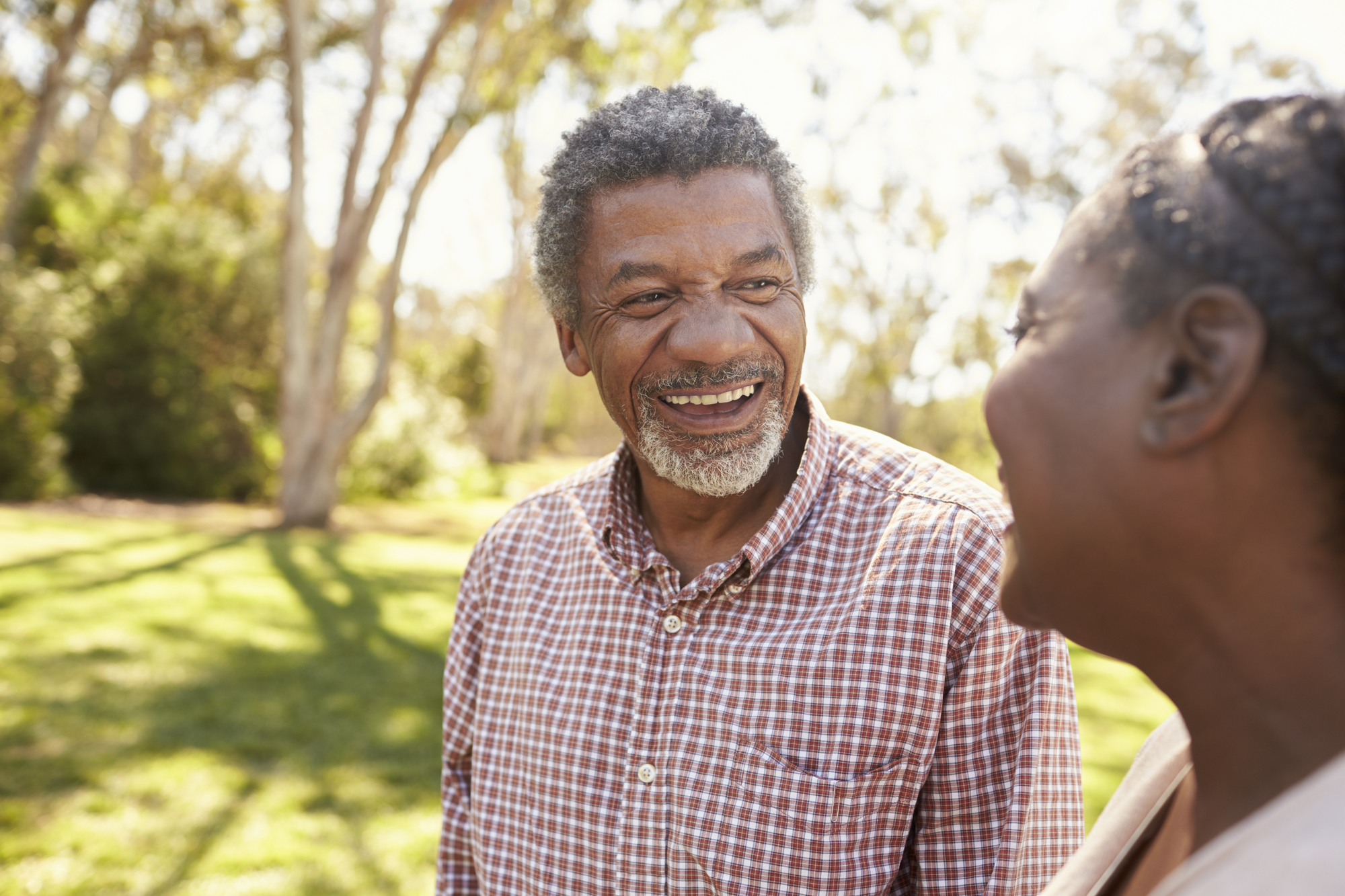 Positive Aging man in checkered shirt smiling